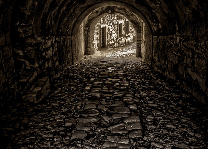 vertical shot empty tunnel towards buildings